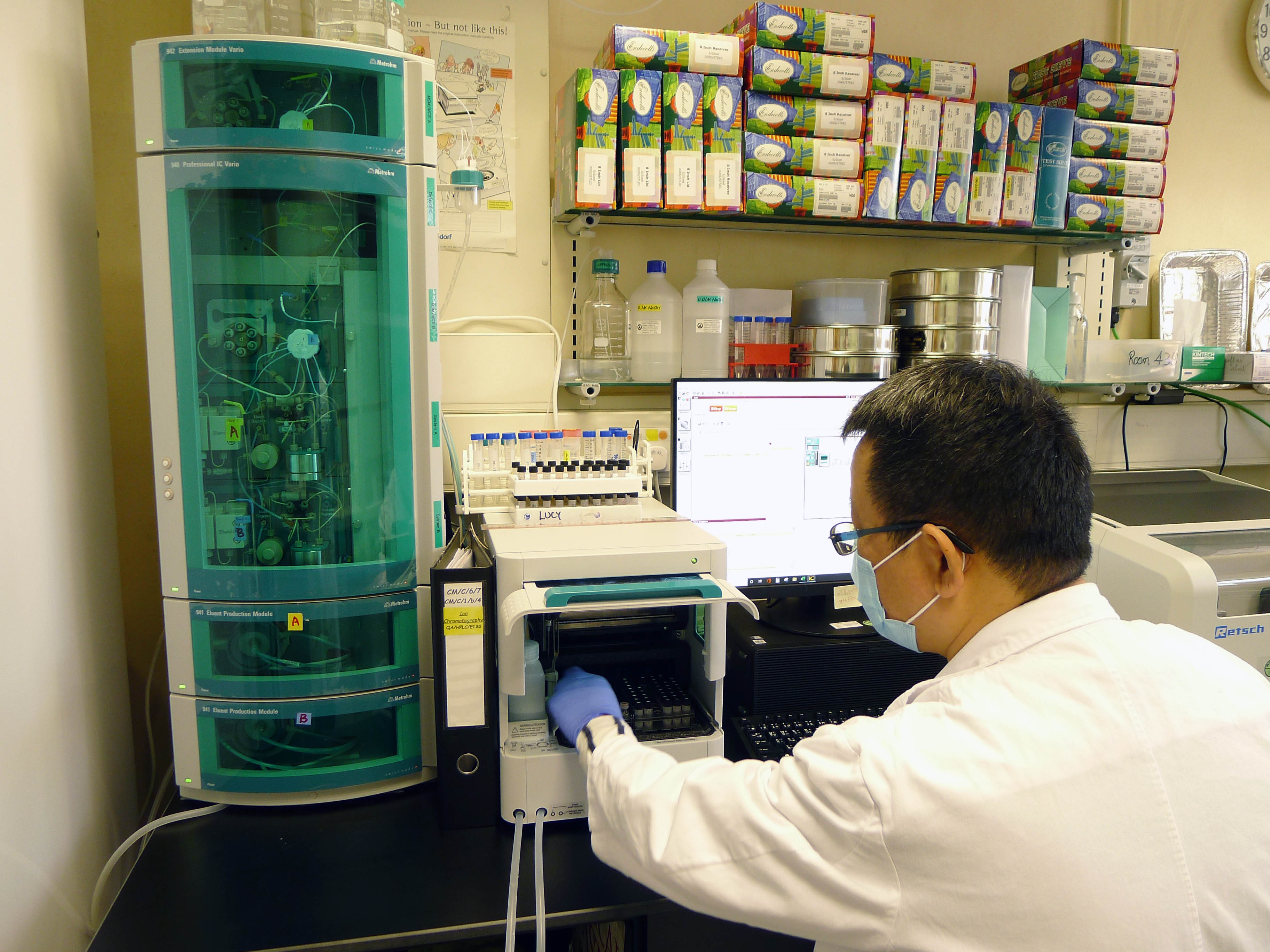 A staff is operating the ion chromatographic system to determine the content of sulphur dioxide in Chinese herbal medicines