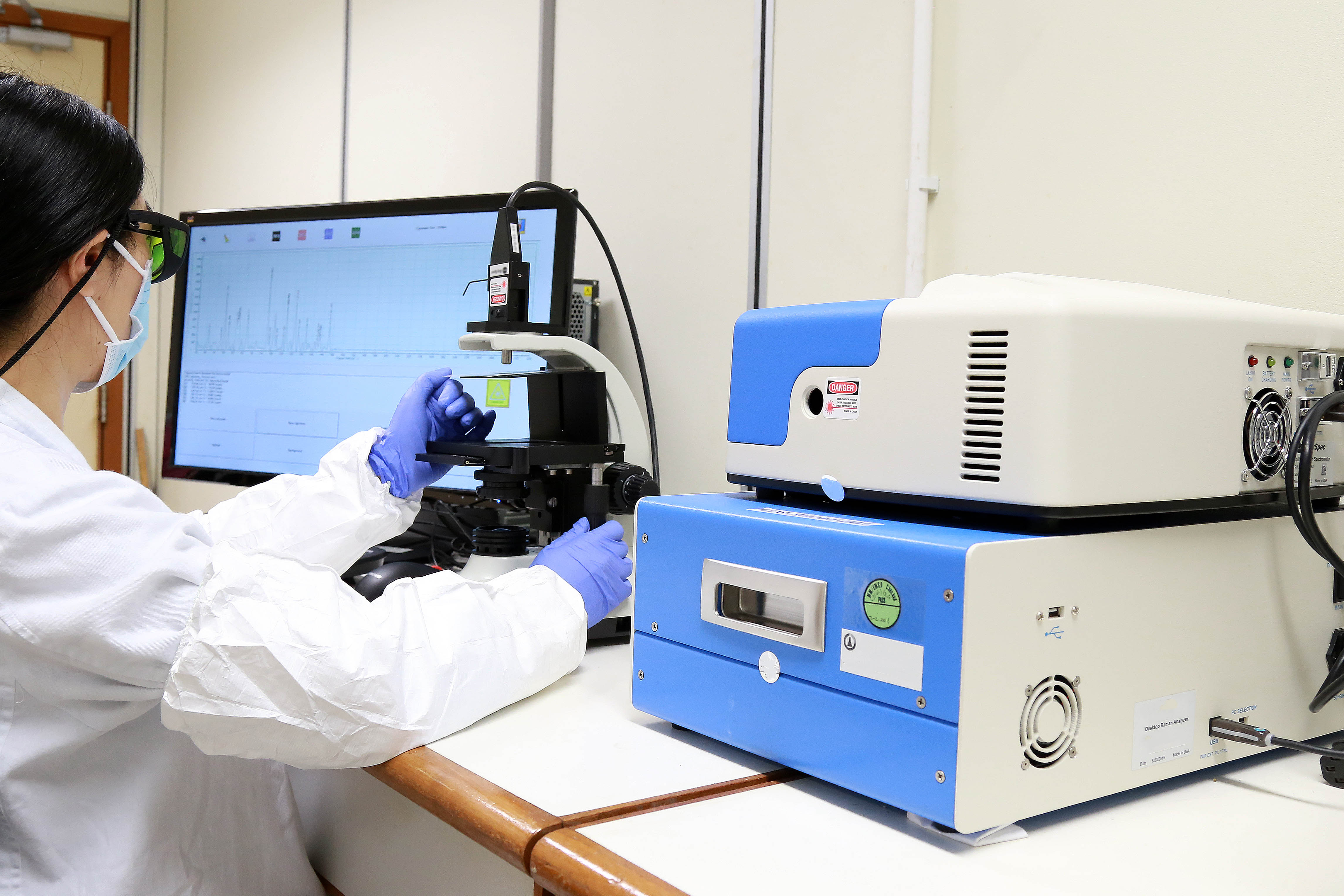 A staff is using a Raman spectrometer for controlled drugs analysis