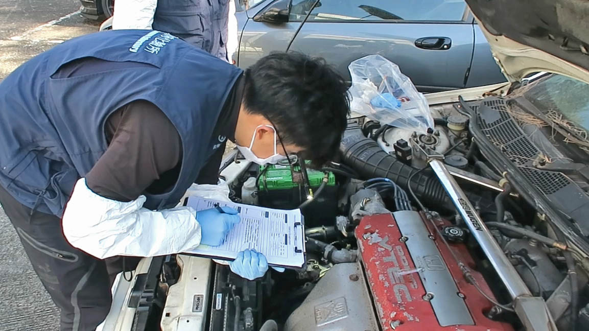 A staff is examining engine numbers